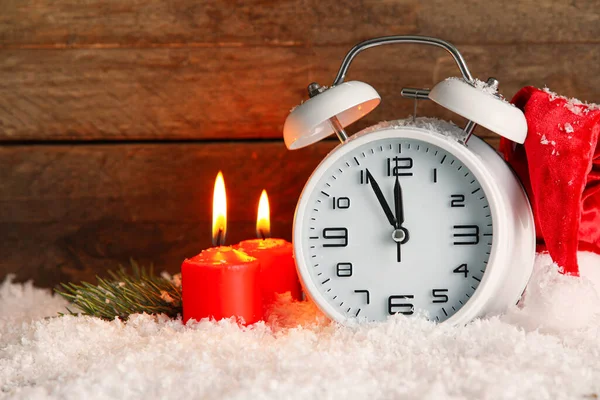 Christmas Alarm Clock Burning Candles Snow Wooden Background — Stock Photo, Image