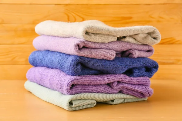 Stack Different Cozy Sweaters Wooden Background — Stock Photo, Image