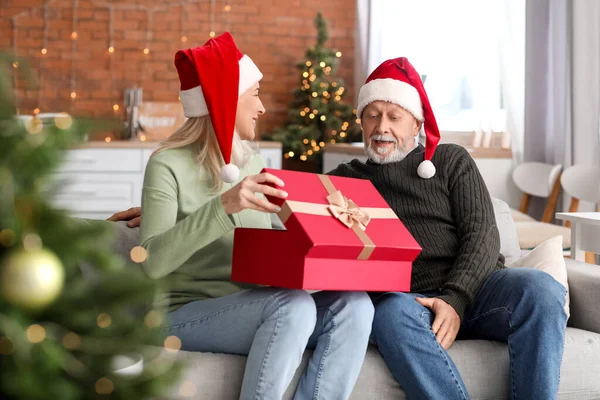 Happy Mature Couple Christmas Gift Sitting Sofa Home — Stock Photo, Image