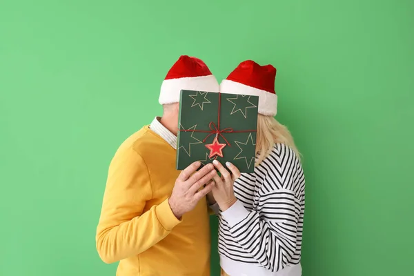 Happy Mature Couple Santa Hats Christmas Gift Color Background — Stock Photo, Image