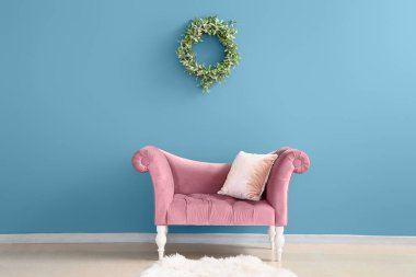 Odanın içinde ökseotu çelengi olan şık rahat bir koltuk.