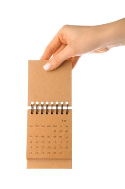 Beyaz arkaplanda el sanatları takvimi tutan kadın