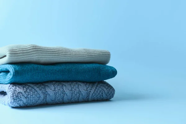 Stack Warm Sweaters Blue Background — Stock Photo, Image