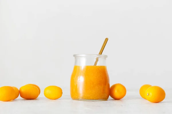 Jar Tasty Kumquat Jam Fresh Fruits Light Background — Stock Photo, Image