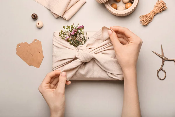 Woman Wrapping Gift Box Fabric Light Background Closeup — Stock Photo, Image