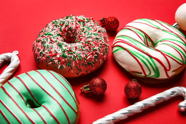 Tasty Christmas Donuts Balls Candy Canes Red Background Closeup — Stock Photo, Image