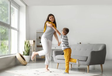 Küçük çocuk evde ablasıyla dans ediyor.