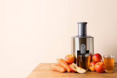 Masasında taze meyve suyu olan modern meyve sıkacağı.