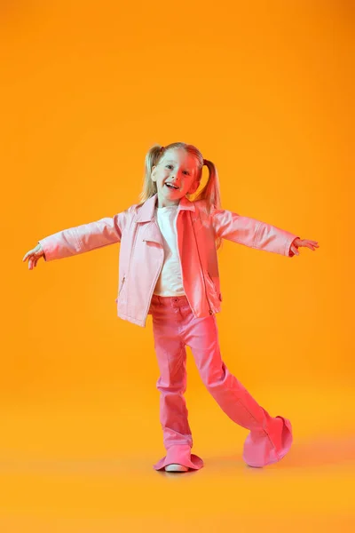 Cute Little Girl Pink Jacket Dancing Orange Background — Stock Photo, Image