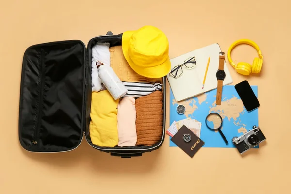 Suitcase Packed Travelling Belongings World Map Color Background — Stock Photo, Image