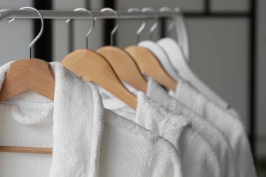 Beyaz bornozlarla dolu bir oda, yakın plan.