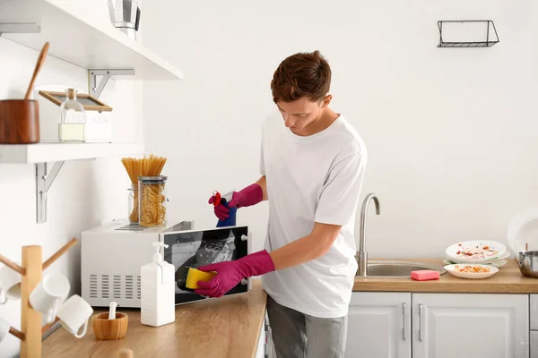 Young Man Cleaning Microwave Sponge Kitchen — Stock Photo, Image
