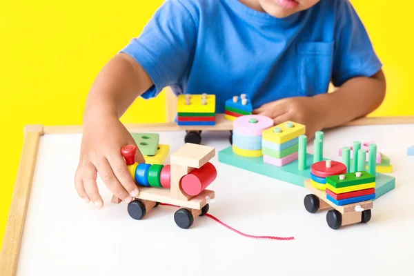 Little Boy Playing Building Blocks Table Yellow Background Closeup — Stock Photo, Image