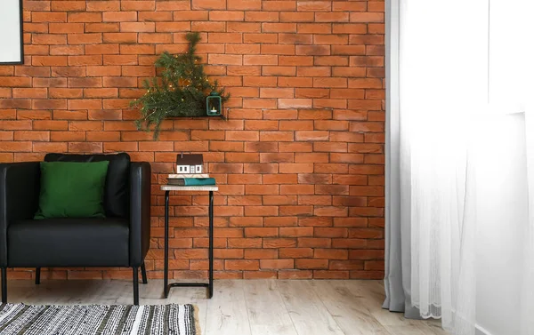 Fir Branches Shelf Armchair Table Brick Wall — Stock Photo, Image