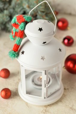 Güzel bir Noel feneri, yanan bir mum ve ışık arka planında toplar.
