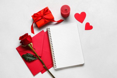 Boş defter, hediye ve zarf içeren romantik kompozisyon