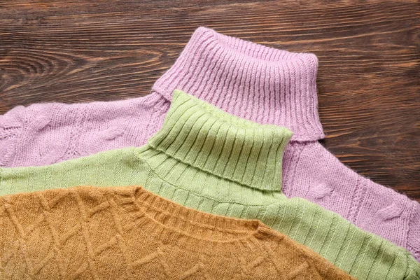 Stylish Knitted Sweaters Wooden Background Closeup — Stock Photo, Image