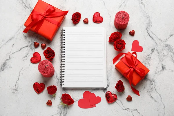 Boş defterli romantik kompozisyon ve beyaz arkaplanda hediyeler