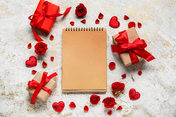Boş defterli romantik kompozisyon ve grunge arkaplanda hediyeler