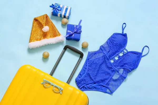 Yellow Suitcase Christmas Gift Boxes Balls Santa Hat Swimsuit Blue — Stock Photo, Image