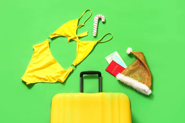 Žlutý Kufr Santovým Kloboukem Cestovním Pasem Dámskými Plavkami Zeleném Pozadí — Stock fotografie