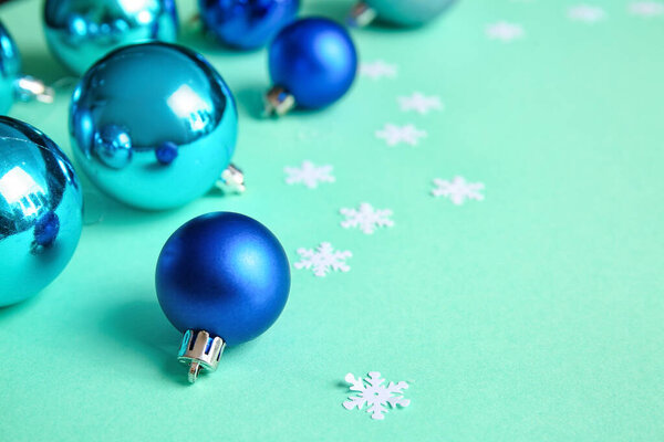 Stylish Christmas balls on green background