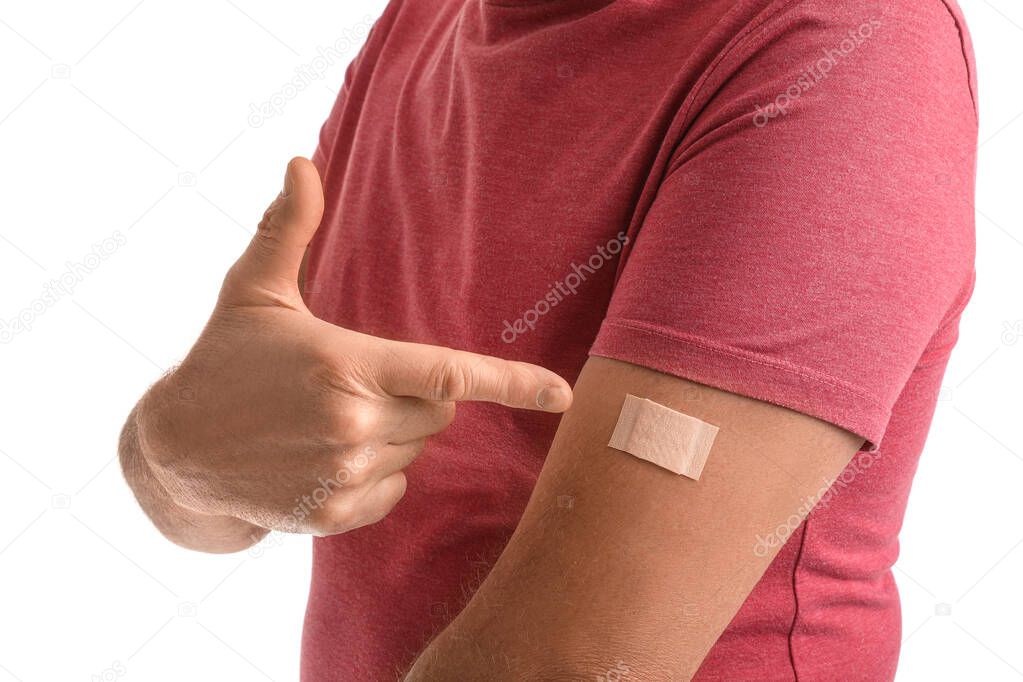Mature man with applied nicotine patch on white background. Smoking cessation