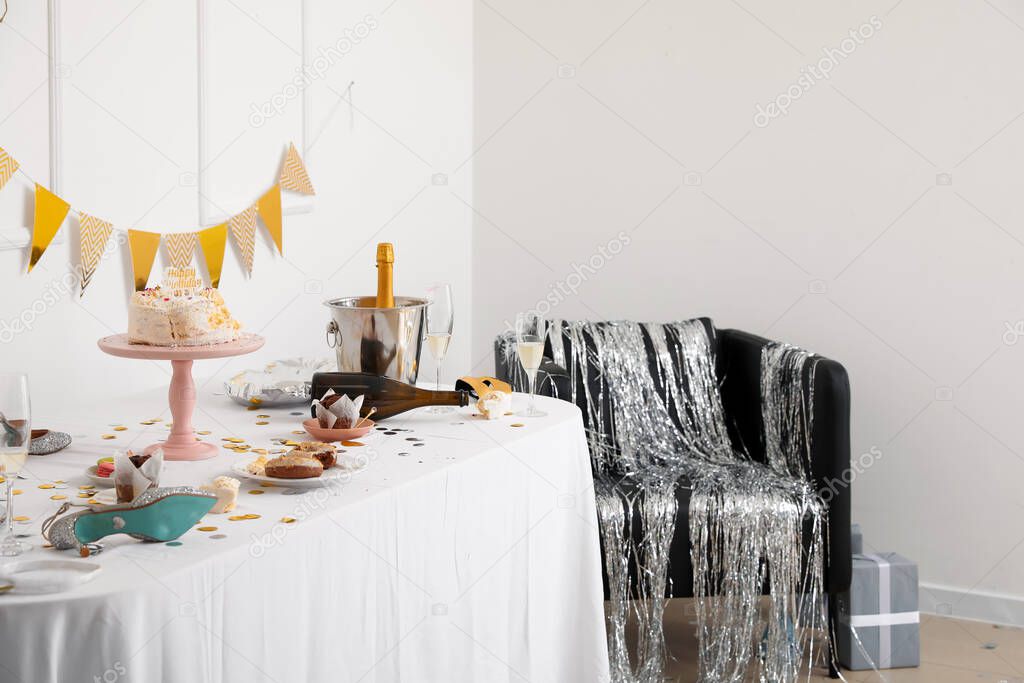 Interior of messy room after party with table and armchair