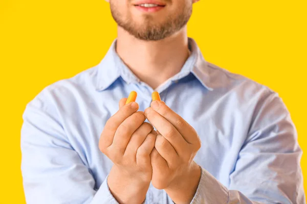 Young Man Ear Plugs Yellow Background Closeup — 图库照片