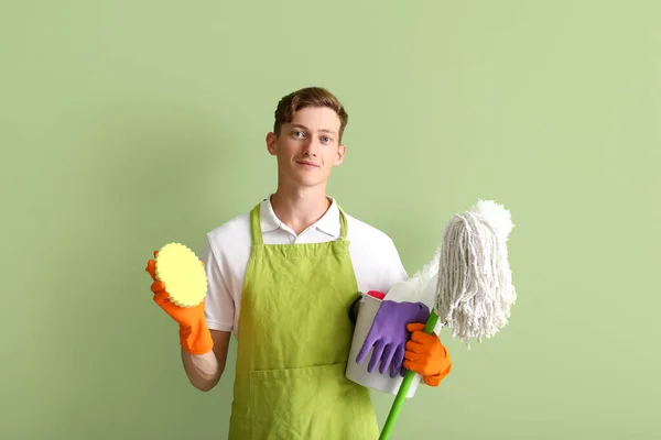 Handsome Man Cleaning Supplies Green Background — Stockfoto
