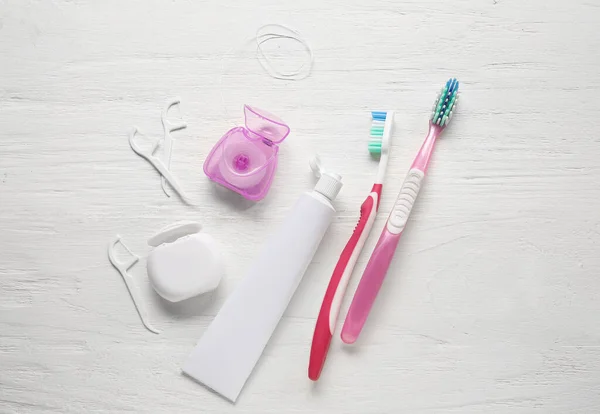 Dental Floss Toothpicks Paste Brushes White Wooden Background — Stock Photo, Image