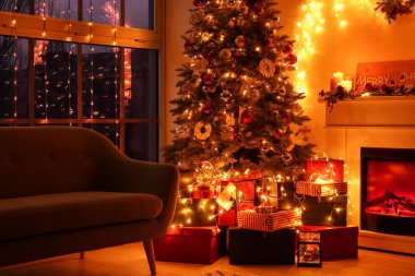 Güzel Noel ağacı ve şöminesi olan şık bir oturma odası.