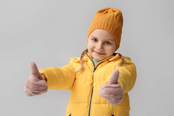 Little Girl Stylish Winter Clothes Showing Thumb Gesture Light Background — Stockfoto