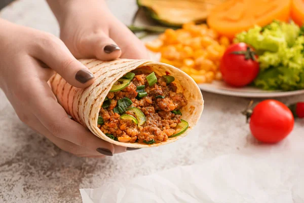 Woman Holding Tasty Burrito Light Background Closeup — Stockfoto