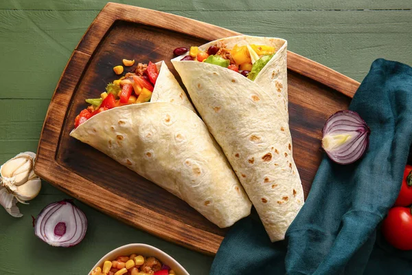 Board Tasty Mexican Burritos Vegetables Green Wooden Background — Stock Photo, Image