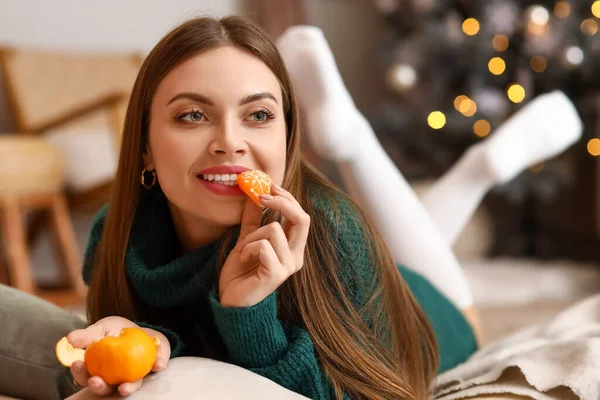 Beautiful Young Woman Eating Tasty Tangerine Home Christmas Eve — Stock Photo, Image