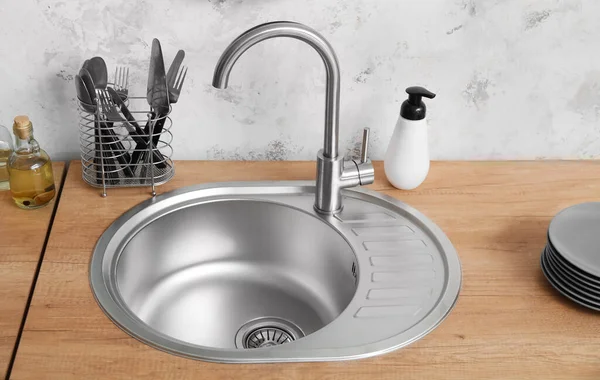 Wooden Counter Silver Sink Cutlery Detergent Light Wall Kitchen — 图库照片