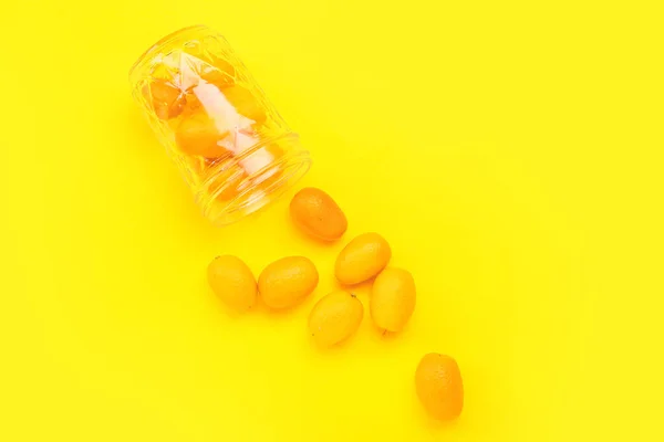 Jar Tasty Kumquat Fruits Yellow Background — Stockfoto