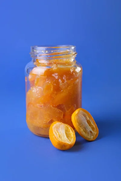 Jar Tasty Kumquat Jam Blue Background — Stock Photo, Image