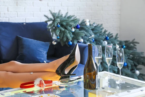 Legs Young Woman Table Empty Champagne Bottle Party — Stock Photo, Image