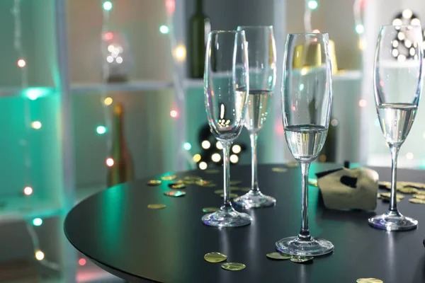 Champagne glasses on table in night club after party