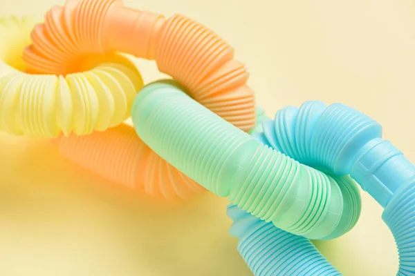 Different Colorful Pop Tubes Beige Background Closeup — Stock Photo, Image