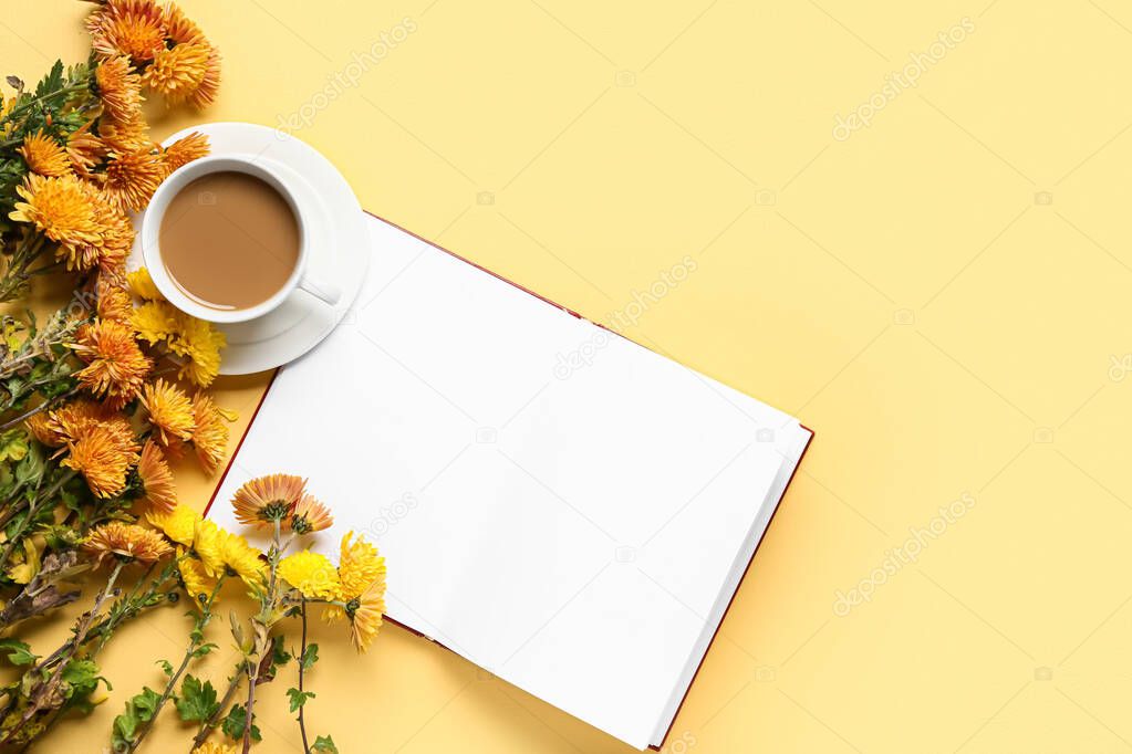 Cup of tasty coffee, book and Chrysanthemum flowers on yellow background