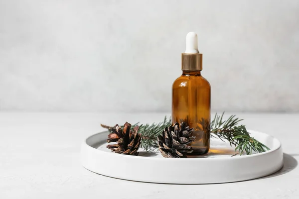 Plate Bottle Essential Oil Fir Branch Pine Cones Light Background — Stock Photo, Image