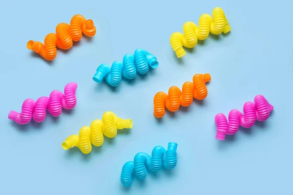 Different Colorful Pop Tubes Blue Background — Stock Photo, Image
