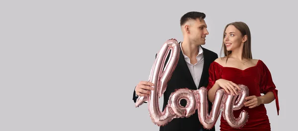 Young Couple Balloon Shape Word Love Grey Background Space Text — Fotografia de Stock