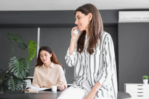 Young Woman Gossiping While Talking Phone Office — Stock Photo, Image