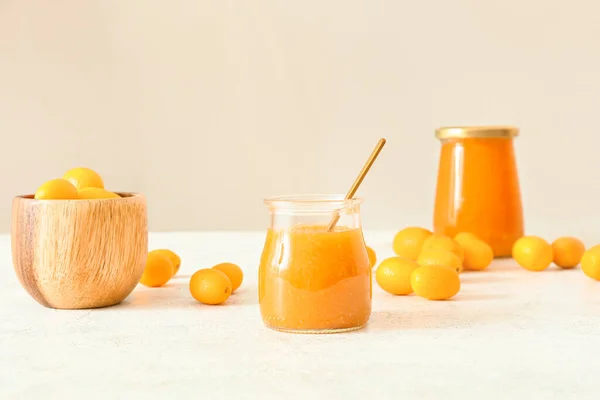 Jar Tasty Kumquat Jam Fresh Fruits Light Background — Stock Photo, Image