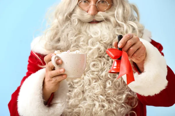 Santa Claus Christmas Bell Cup Cocoa Blue Background Closeup — Stock Photo, Image