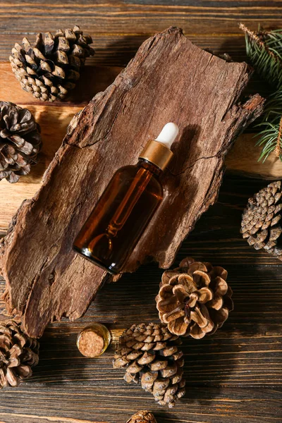 Composition Bottle Essential Oil Pine Cones Tree Bark Wooden Background — Fotografia de Stock